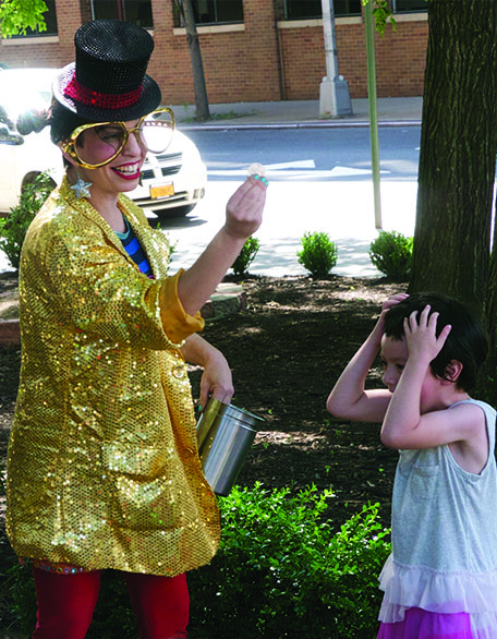 NYC magician Razzle Dazzle pulls coin from kid's ear