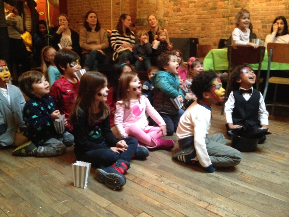 Kids watching NYC magician Razzle Dazzle